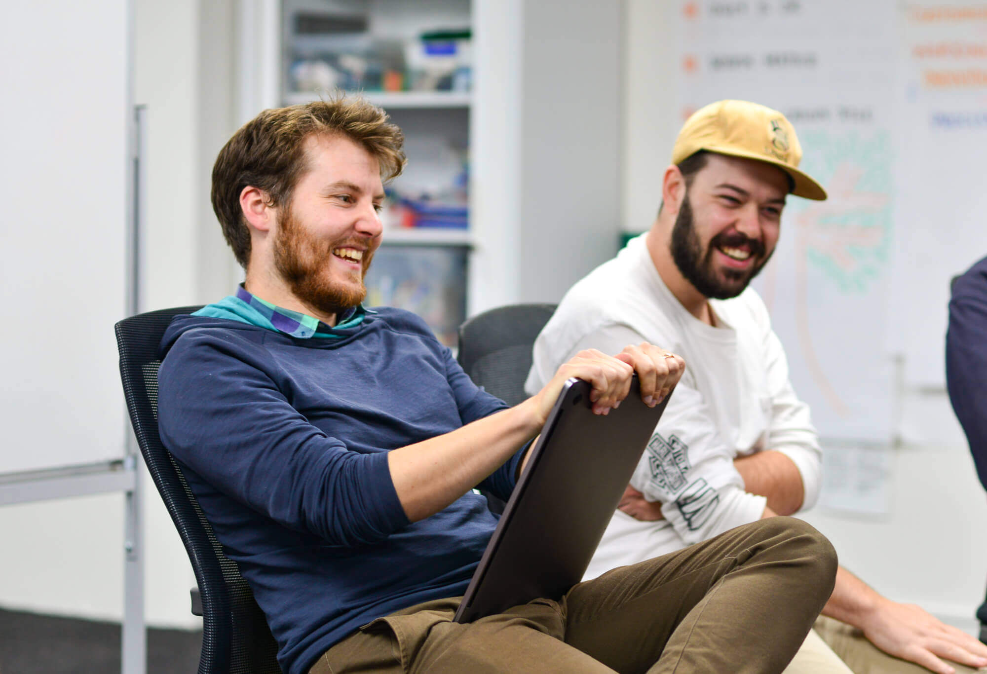 A couple of Boosters enjoying a discussion with a client who has joined us in the Boost studio to collaborate on their project.