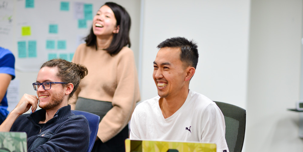 A couple of Boosters enjoying a discussion with a client who has joined us in the Boost studio to collaborate on their project.