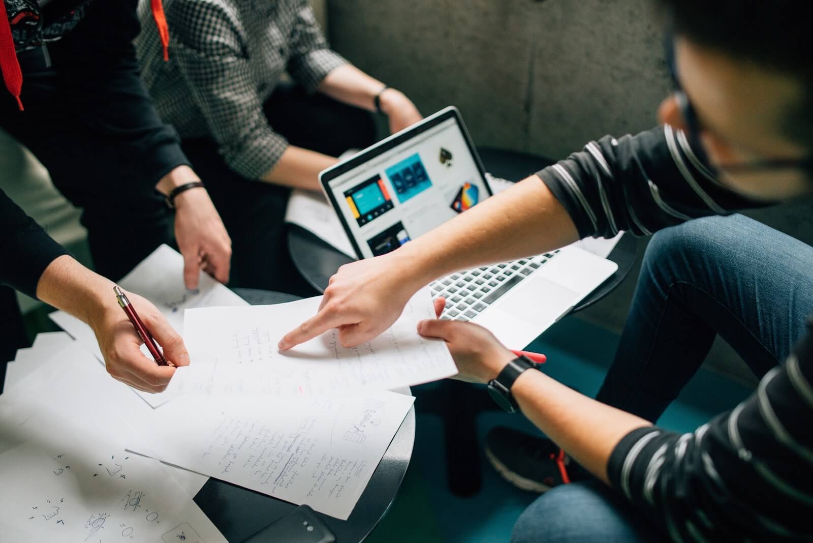 A Product Owner discusses a user story with a developer and the Scrum Master.