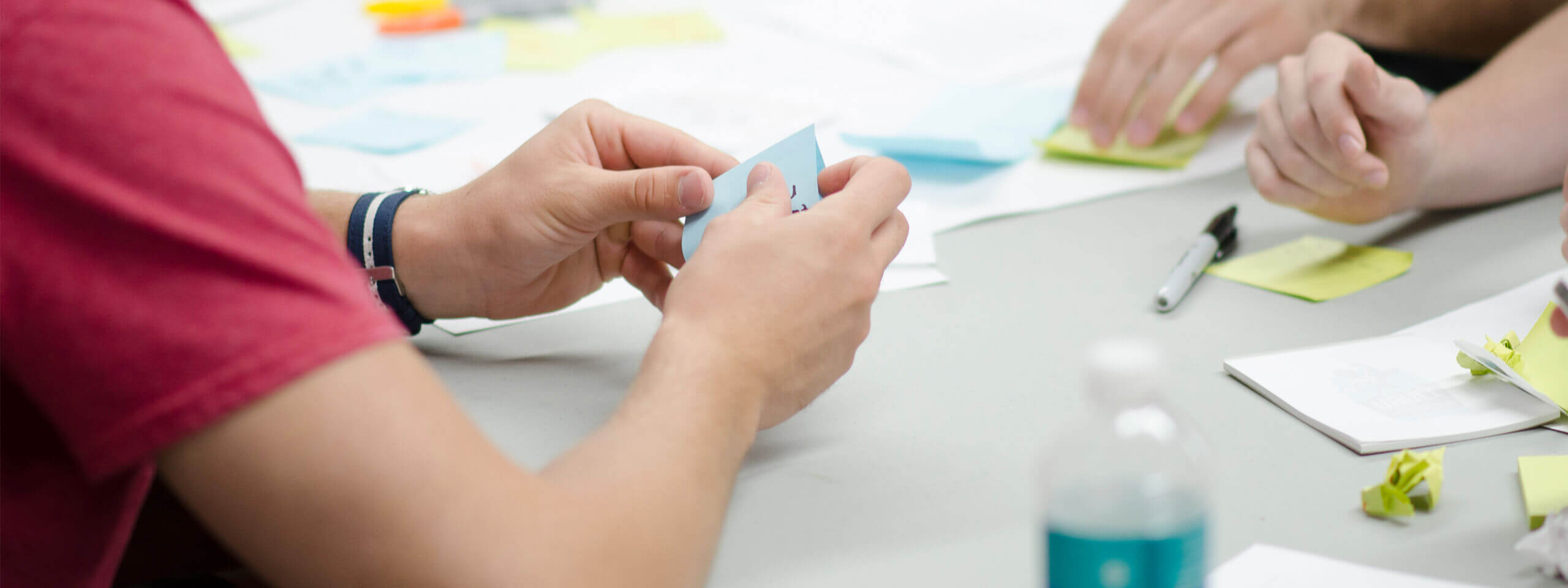 Project team members work on user stories at a kick-off workshop.