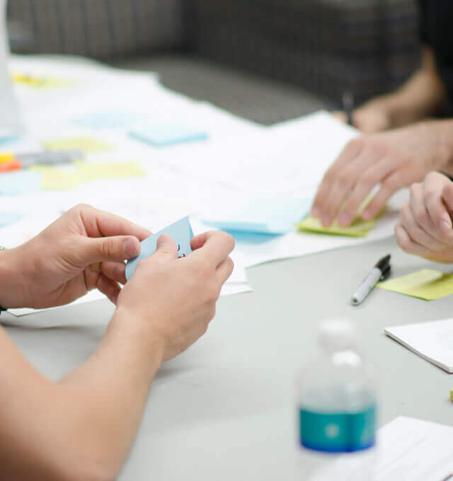 Project team members work on user stories at a kick-off workshop.