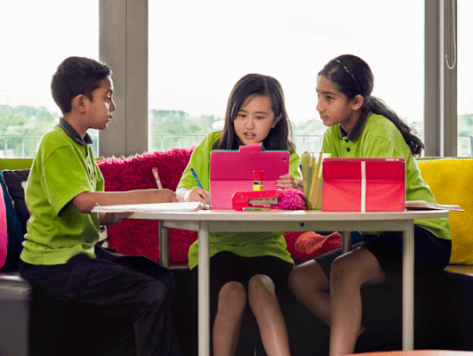 Three school kids checking out resources they’ve found online with help from the AnyQuestions librarians.